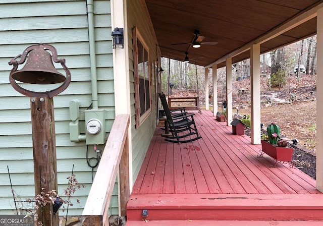 wooden deck with covered porch and ceiling fan