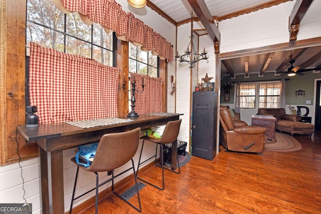 bar with ceiling fan with notable chandelier, plenty of natural light, wood-type flooring, and wood ceiling