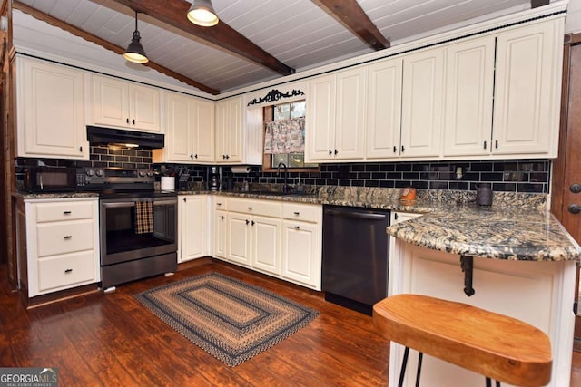 kitchen featuring black appliances, backsplash, dark hardwood / wood-style flooring, sink, and dark stone countertops