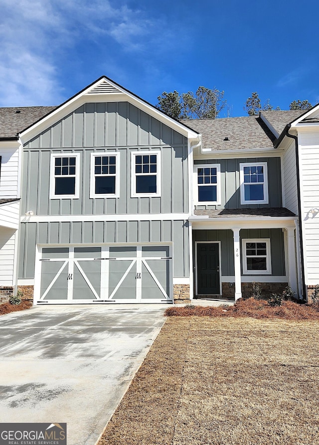 26 Russet Way Lot 61, Newnan, GA 30263 - view of front of property with board and batten siding, concrete driveway, stone siding, and roof with shingles