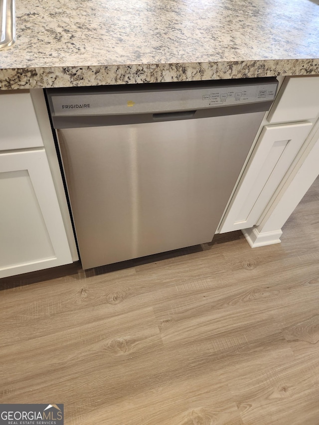 26 Russet Way Lot 61, Newnan, GA 30263 - kitchen view of stainless steel dishwasher, white cabinets, light wood finished floors, and light countertops