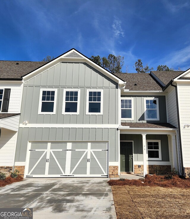 26 Russet Way Lot 61, Newnan, GA 30263 - view of front of house featuring a garage, concrete driveway, board and batten siding, and roof with shingles