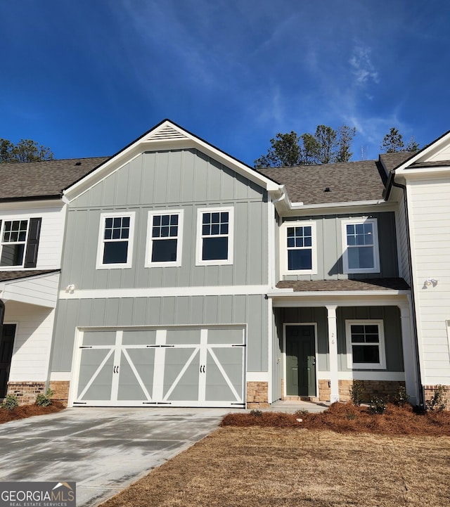 26 Russet Way Lot 61, Newnan, GA 30263 - view of front of property featuring an attached garage, driveway, board and batten siding, a shingled roof, and stone siding
