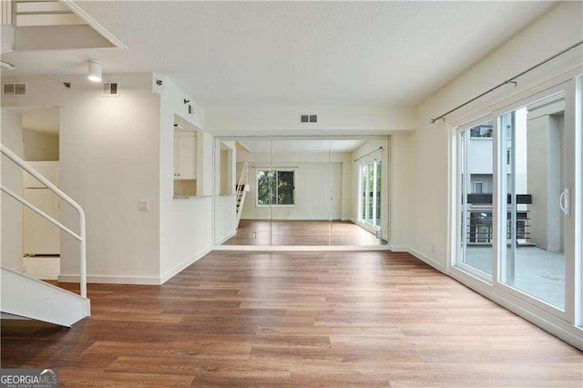 unfurnished room featuring hardwood / wood-style flooring