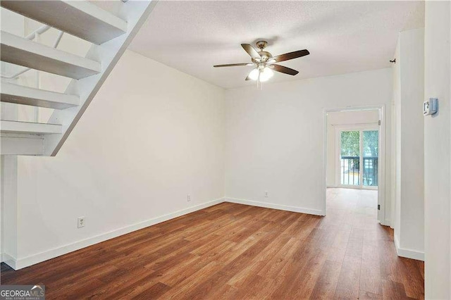 interior space with ceiling fan, a textured ceiling, and hardwood / wood-style floors