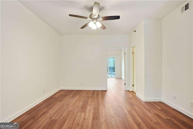 spare room featuring ceiling fan and light hardwood / wood-style flooring