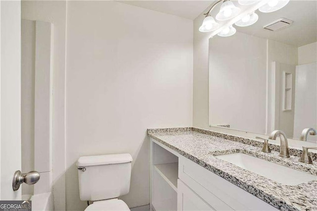 bathroom featuring vanity and toilet