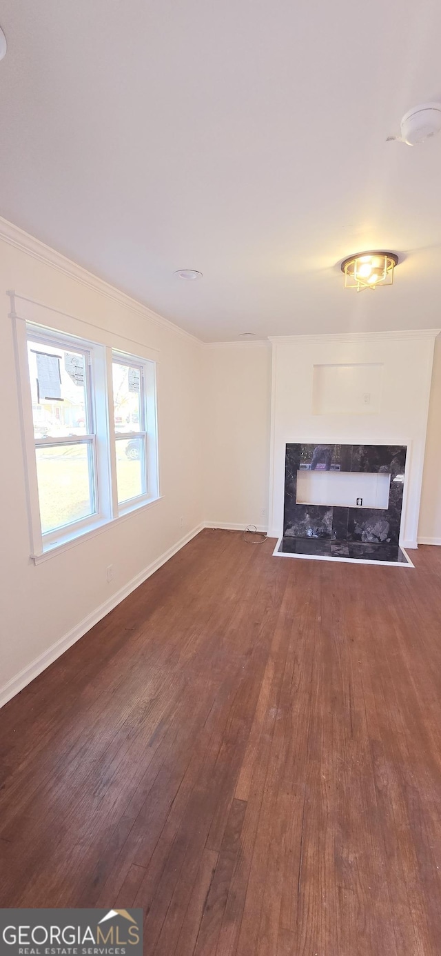 unfurnished living room featuring dark hardwood / wood-style flooring and a premium fireplace