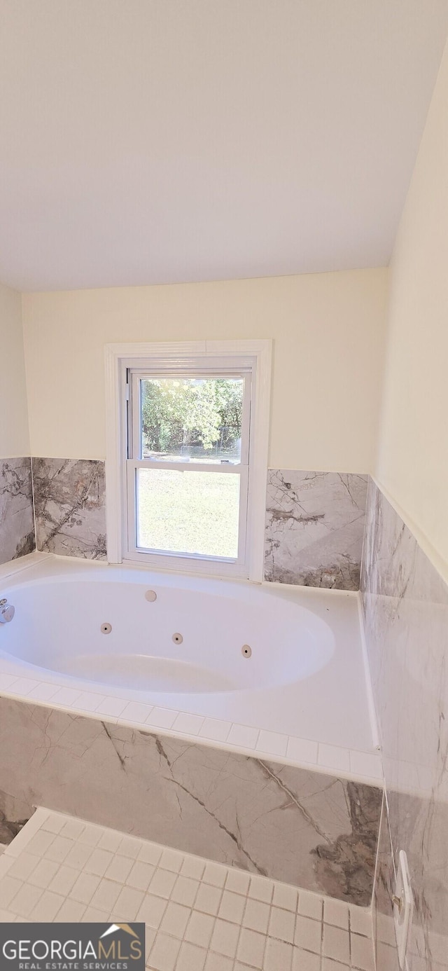 bathroom featuring tiled tub