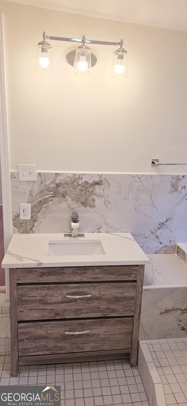 bathroom featuring tile walls and vanity