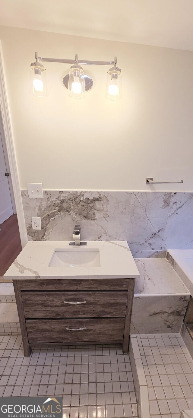 bathroom featuring tile walls and vanity