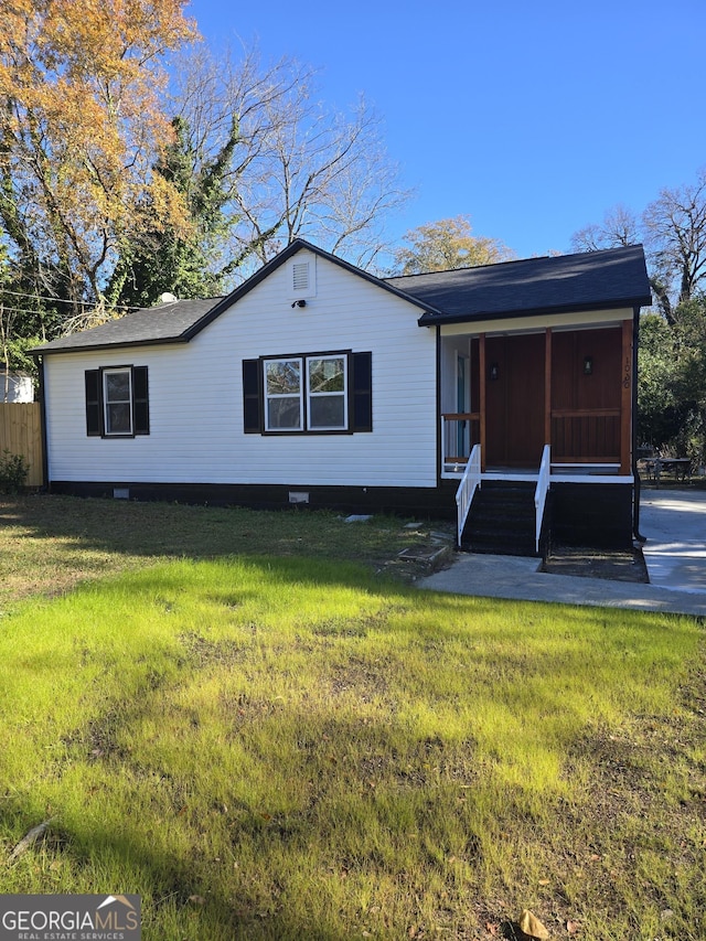 view of front of house with a porch, a sunroom, and a front lawn