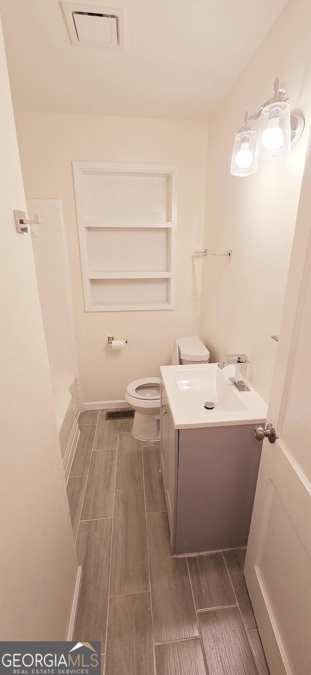 bathroom featuring toilet and vanity