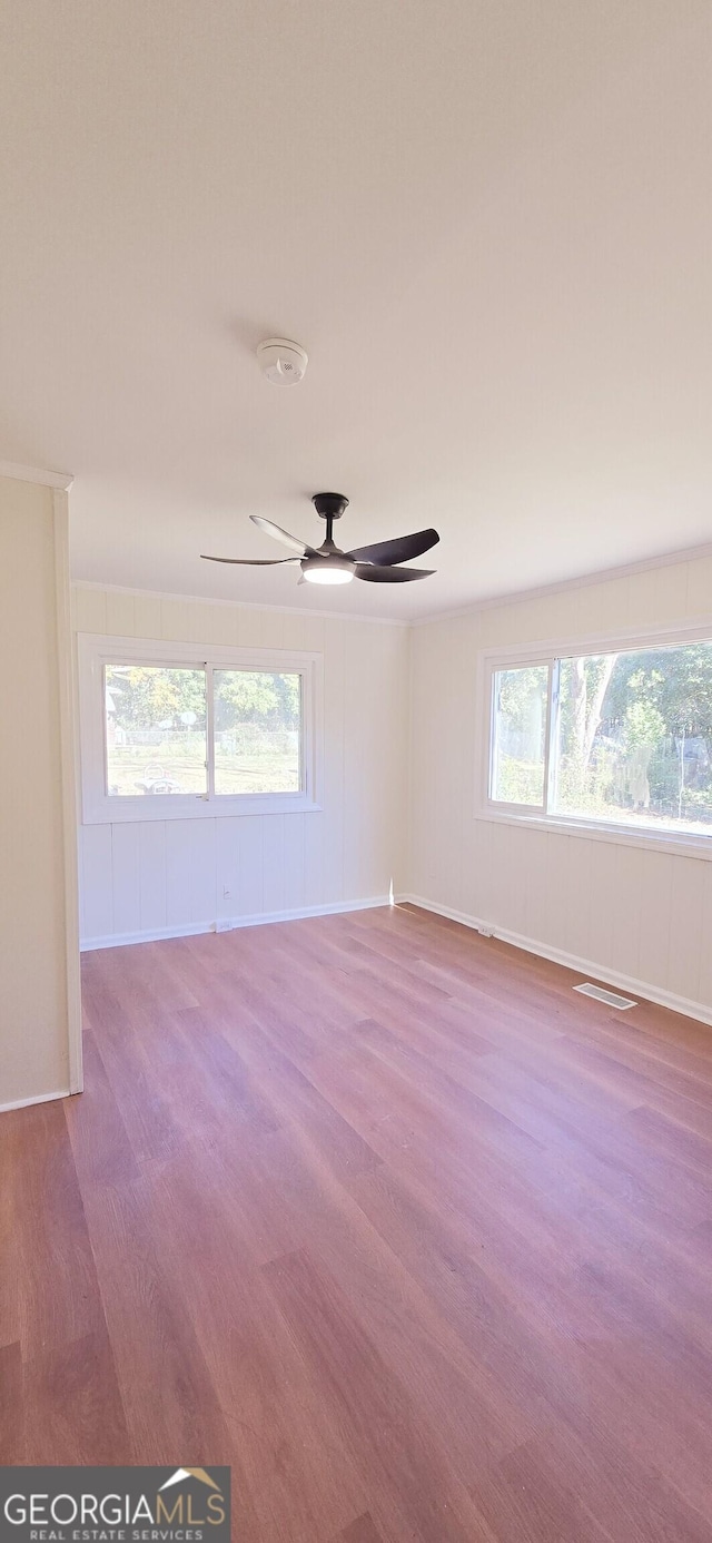 empty room featuring ceiling fan and wood-type flooring