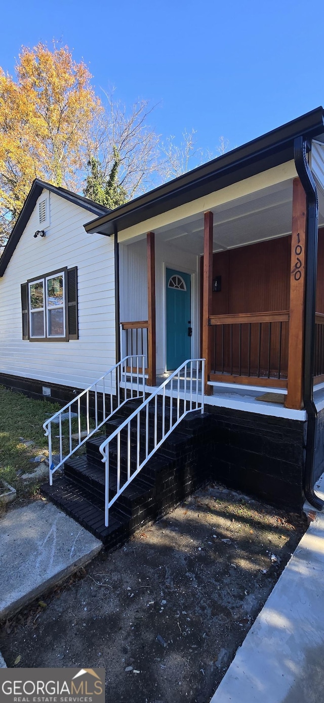 doorway to property featuring covered porch