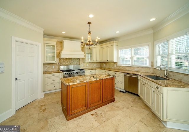 kitchen featuring sink, custom exhaust hood, a kitchen island, stainless steel appliances, and hanging light fixtures