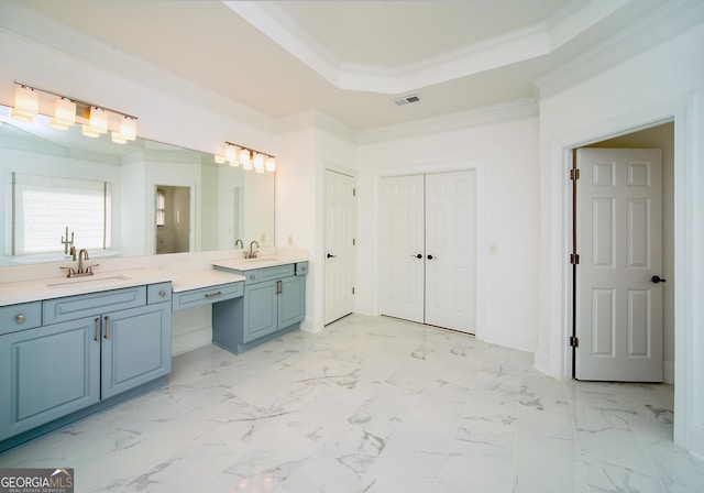 bathroom with a tray ceiling, ornamental molding, and vanity