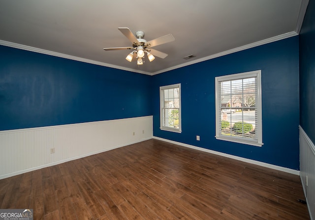 spare room with dark hardwood / wood-style floors, ceiling fan, and ornamental molding