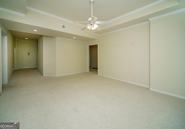 carpeted spare room featuring ceiling fan and crown molding