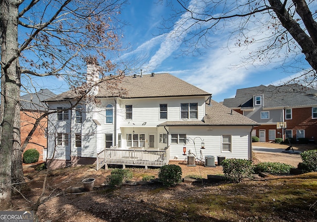 back of property featuring cooling unit and a wooden deck