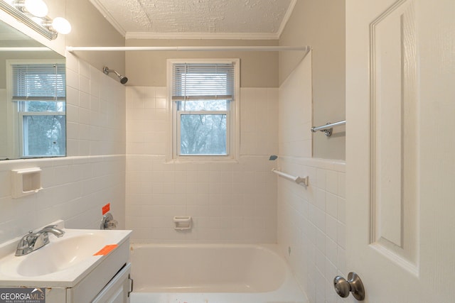 bathroom featuring washtub / shower combination, ornamental molding, a textured ceiling, and vanity