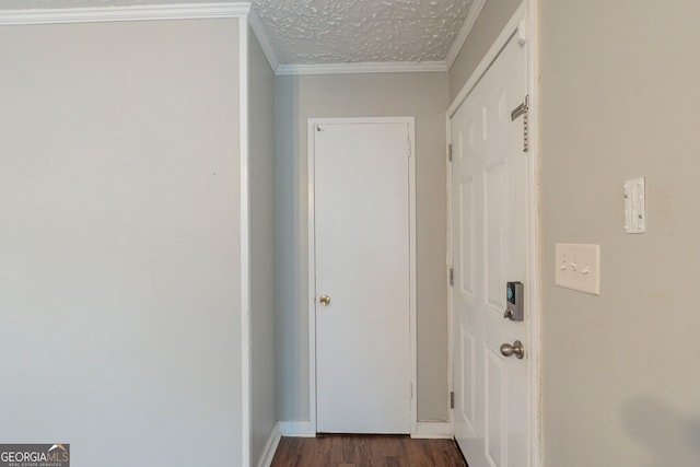 doorway to outside featuring ornamental molding, dark hardwood / wood-style floors, and a textured ceiling