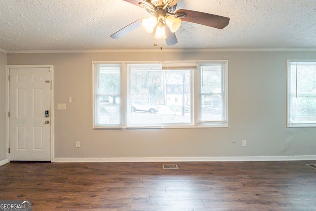 entryway with dark wood-type flooring, visible vents, and crown molding