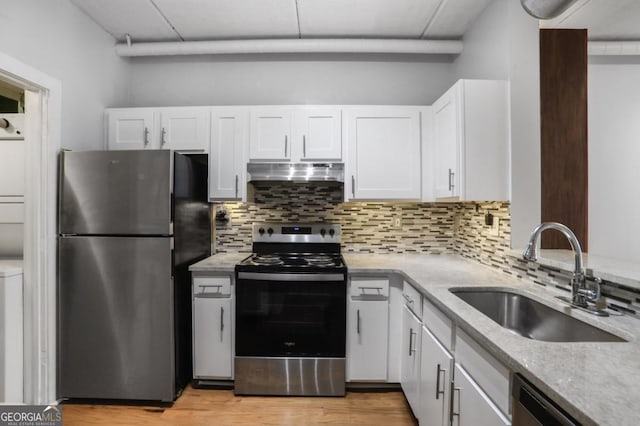 kitchen with tasteful backsplash, light wood-type flooring, stainless steel appliances, sink, and white cabinetry