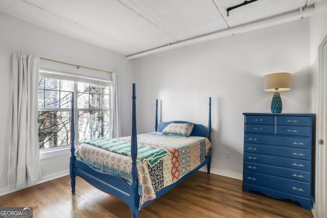 bedroom with dark hardwood / wood-style flooring