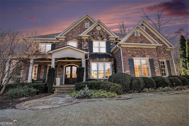 craftsman-style home featuring a yard and french doors