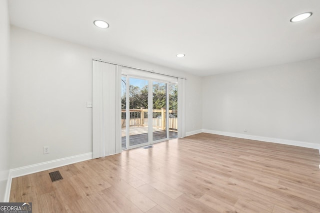 unfurnished room with light wood-style floors, recessed lighting, visible vents, and baseboards