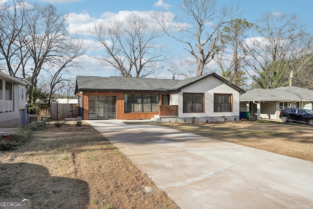 view of front facade with concrete driveway and a front yard