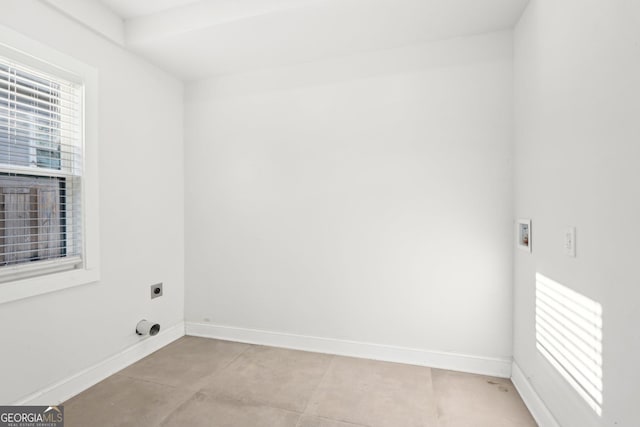 laundry area with laundry area, hookup for an electric dryer, and baseboards