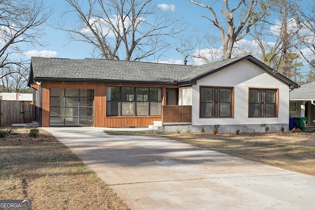 view of front of house featuring a garage, crawl space, roof with shingles, and concrete driveway