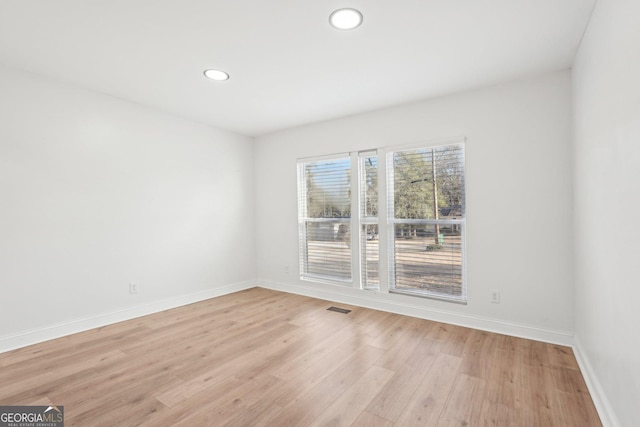 spare room with baseboards, recessed lighting, visible vents, and light wood-style floors