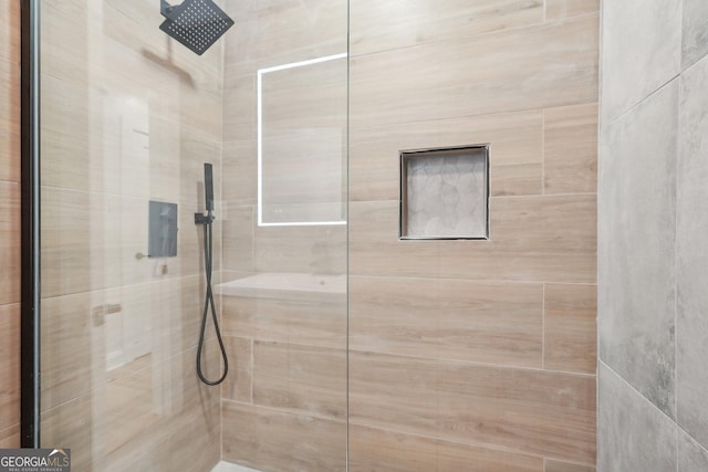 full bath featuring a tile shower