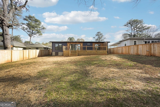 back of house with a sunroom, a fenced backyard, and a yard