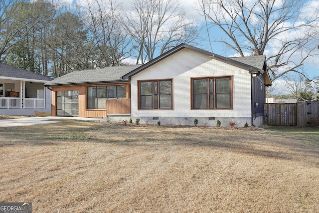 view of front of home featuring crawl space, fence, a front lawn, and brick siding