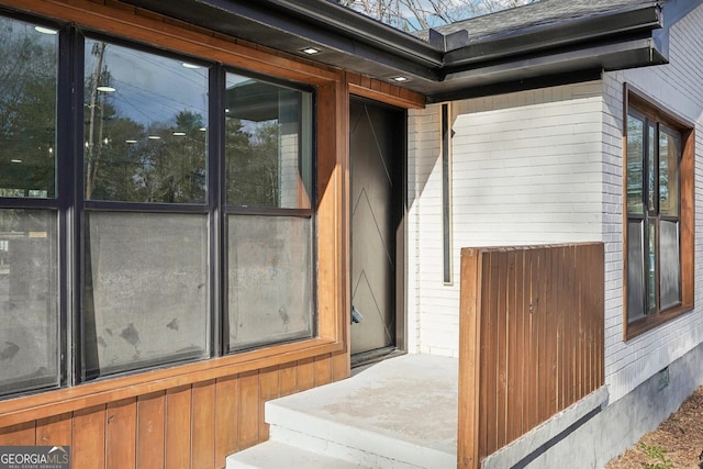 property entrance with brick siding