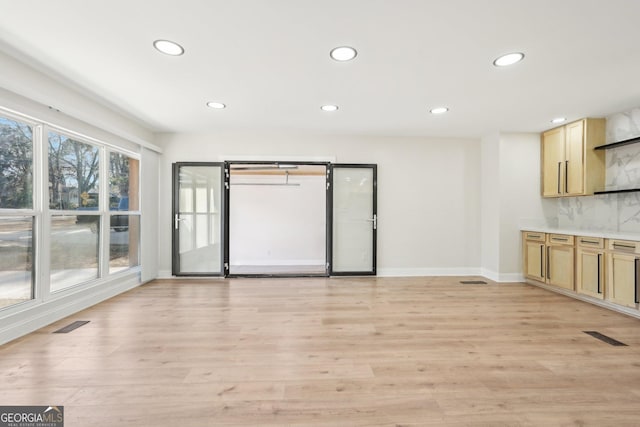 unfurnished living room with visible vents, baseboards, light wood-style flooring, and recessed lighting