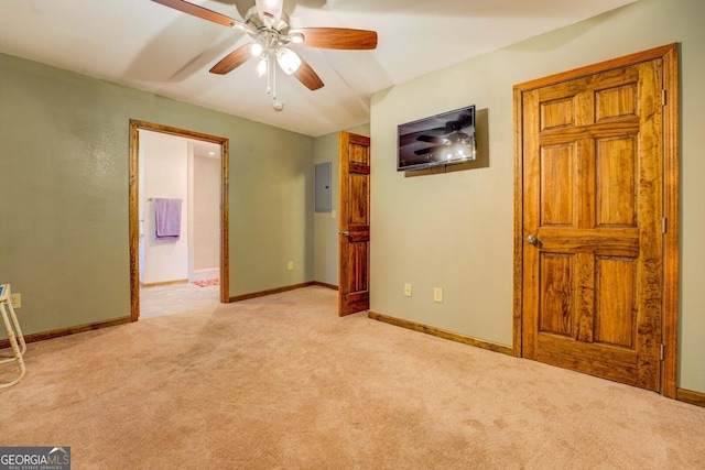 carpeted empty room featuring electric panel and ceiling fan