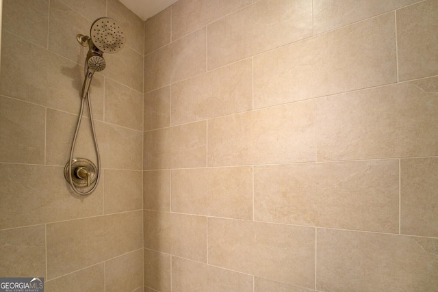 interior details featuring a tile shower