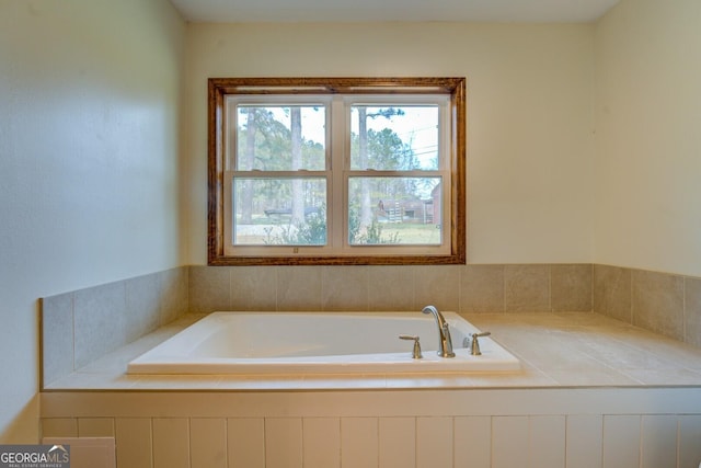 bathroom with a relaxing tiled tub