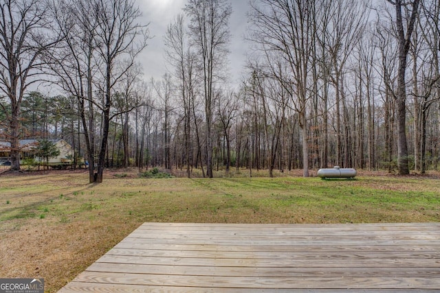 wooden deck featuring a yard