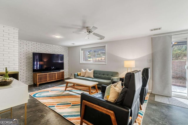 living room with concrete flooring, visible vents, and ceiling fan