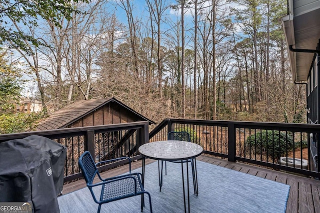 wooden terrace with area for grilling