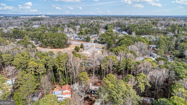 birds eye view of property featuring a wooded view