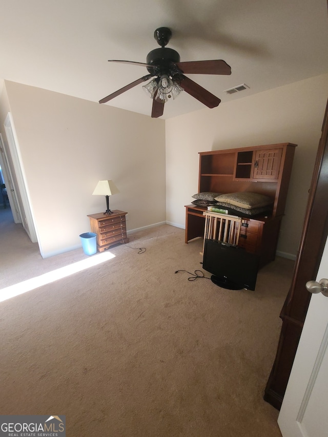 unfurnished bedroom featuring visible vents, a ceiling fan, and light colored carpet