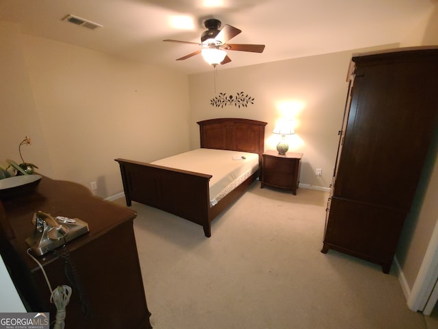 bedroom featuring light colored carpet, visible vents, ceiling fan, and baseboards