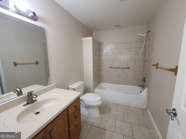 bathroom featuring baseboards, toilet, tile patterned flooring, vanity, and washtub / shower combination